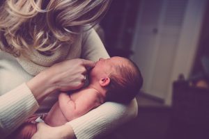 A mom holding an infant