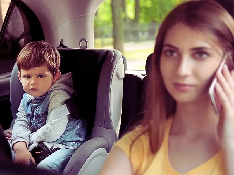 Mother talking by phone while driving car with her son on backseat. children involved in a Texas car accident