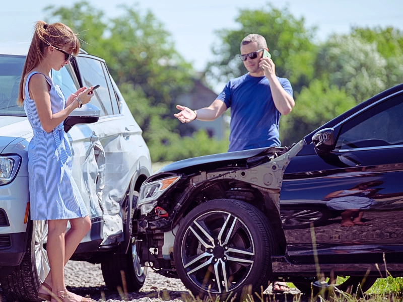 Drivers of smashed vehicles talking on cellphone calling for help in car crash accident. Texas at-fault laws
